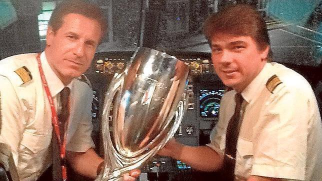 Boned, left, with the UEFA Super Cup and co-pilot Alejandro Buxonet. (ABC)